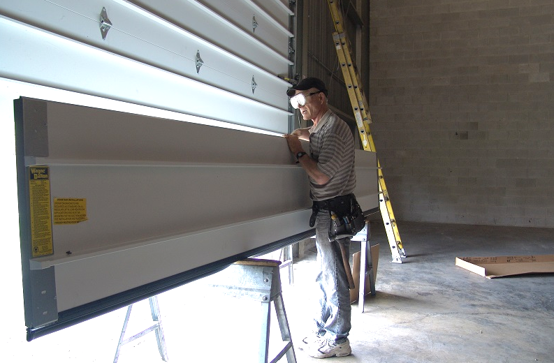 Professional team installing a high-quality garage door at a residential property in Gahanna, Ohio, demonstrating precision and care during the seamless garage door installation process.