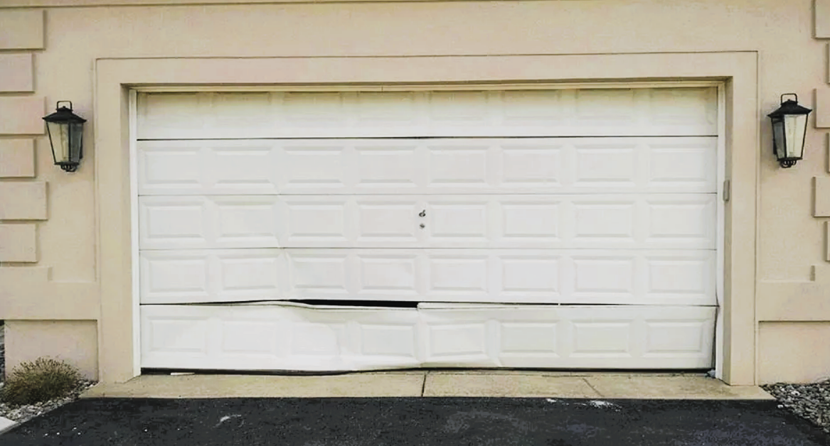 Image showing a technician performing garage door section replacement in Gahanna, Ohio, highlighting professional garage door repair services.