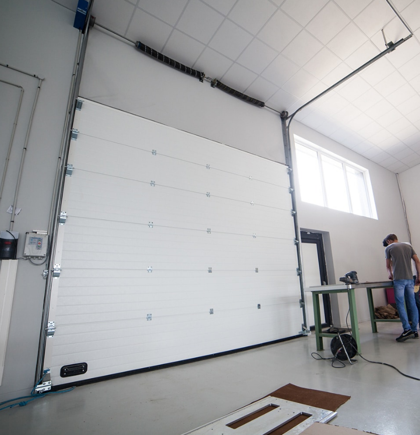 A technician performing garage door panel repair on a residential garage door in Gahanna, Ohio.