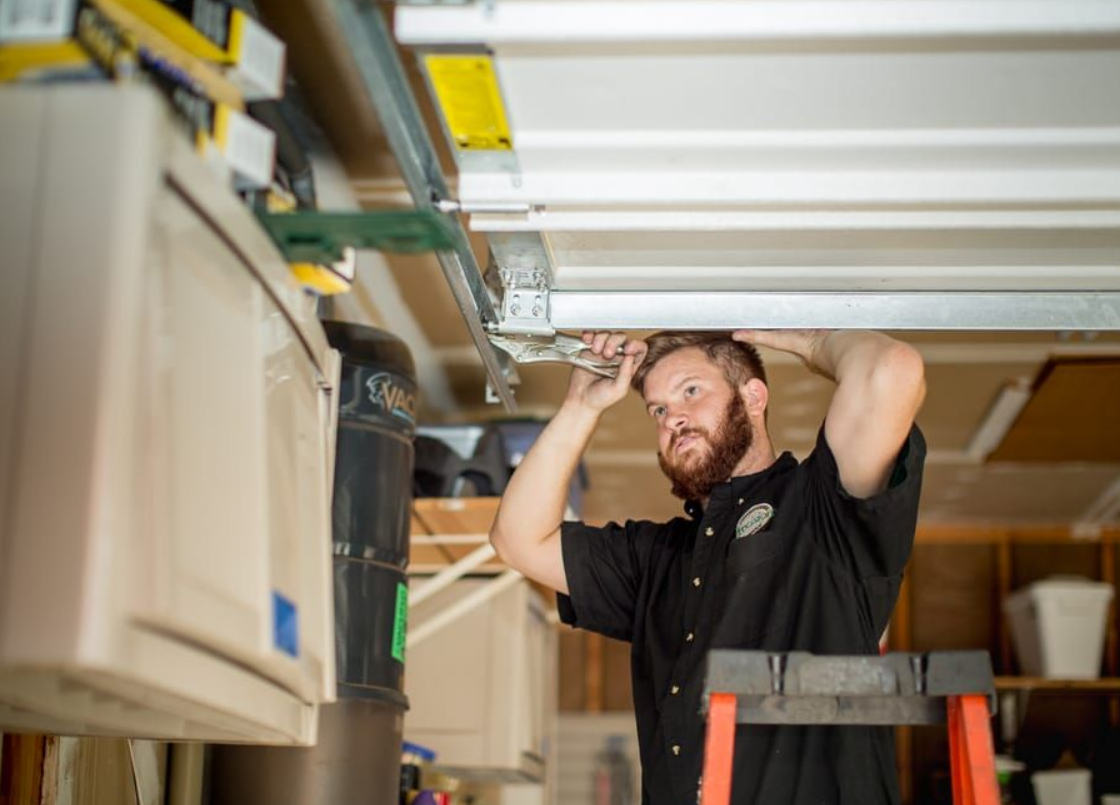 Technician performing overhead garage door repair on a residential garage in Gahanna, Ohio.