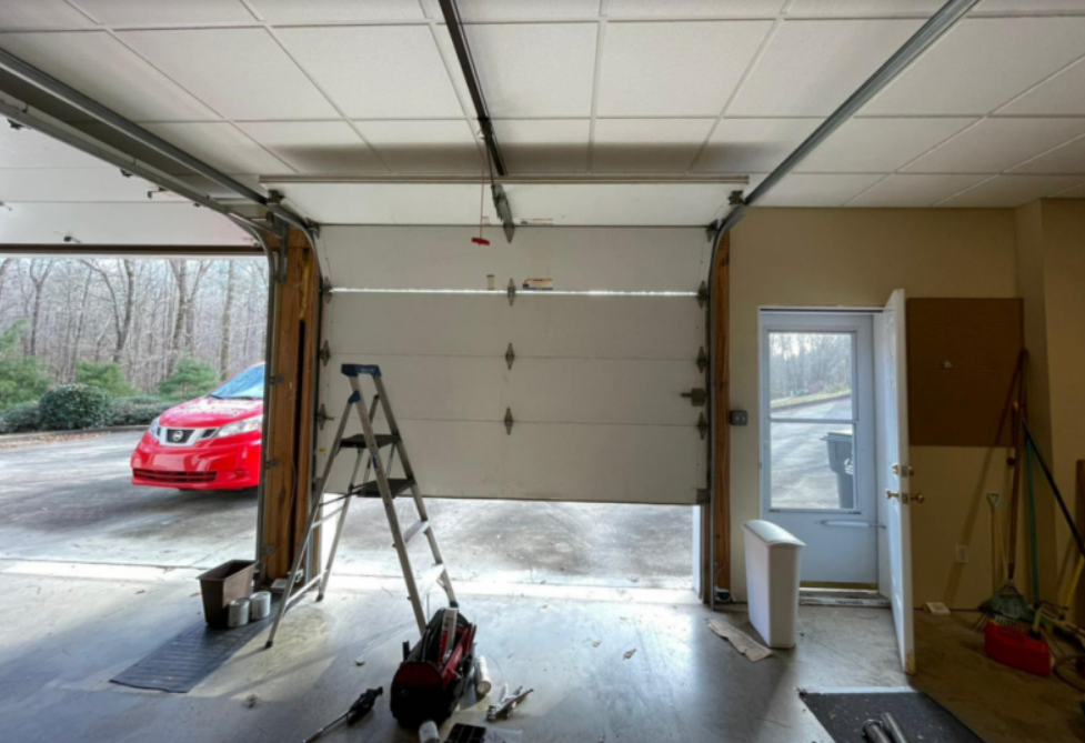 A technician performing garage door spring repair on a residential garage door in Gahanna, Ohio