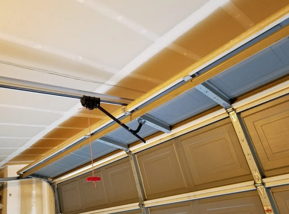 : Technician performing overhead garage door repair on a residential garage in Gahanna, Ohio
