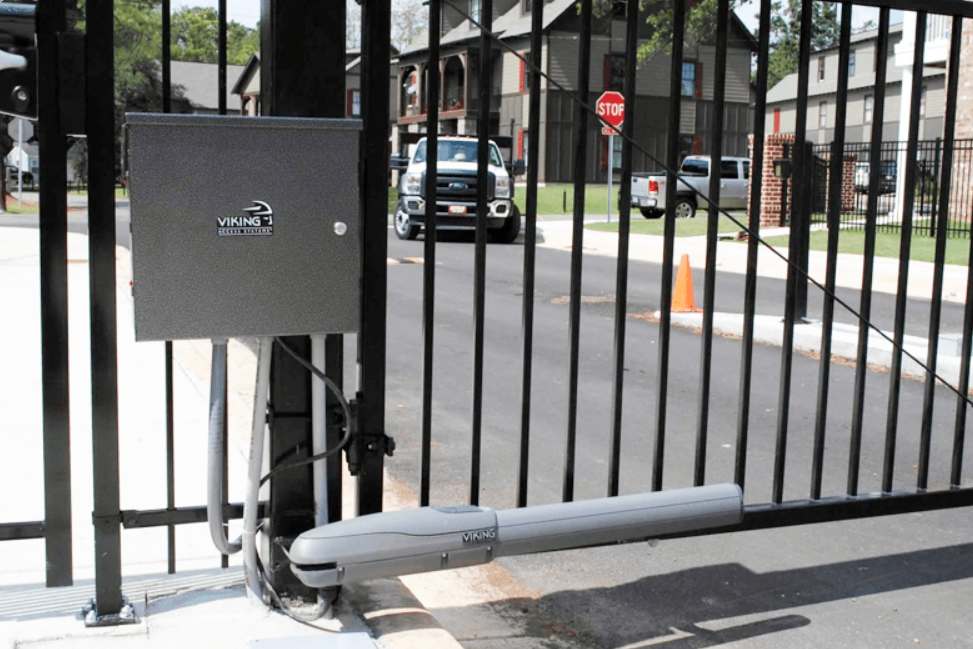 A technician performing commercial gate repair in Gahanna, Ohio, using specialized tools next to a garage door.