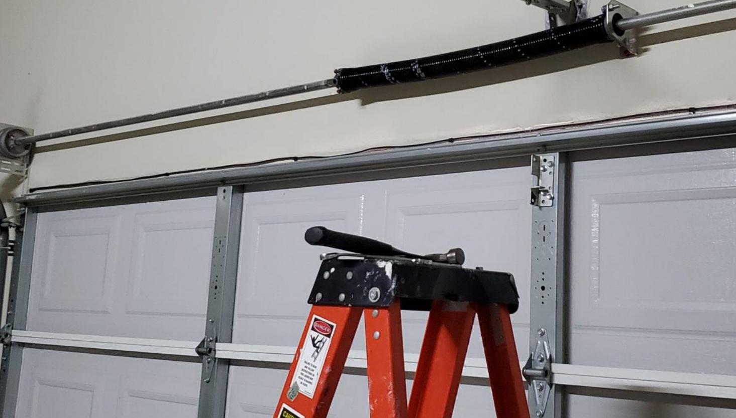 Professional technician performing garage door spring repair service in Gahanna, Ohio