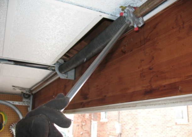 Technician performing garage door spring repair in Gahanna, Ohio