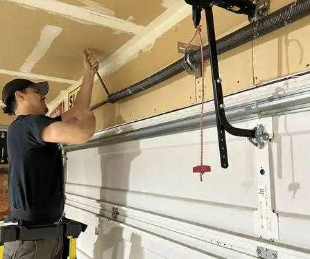 Close-up view of garage door spring repair in progress in Gahanna, Ohio, showcasing professional maintenance for enhanced safety and functionality.