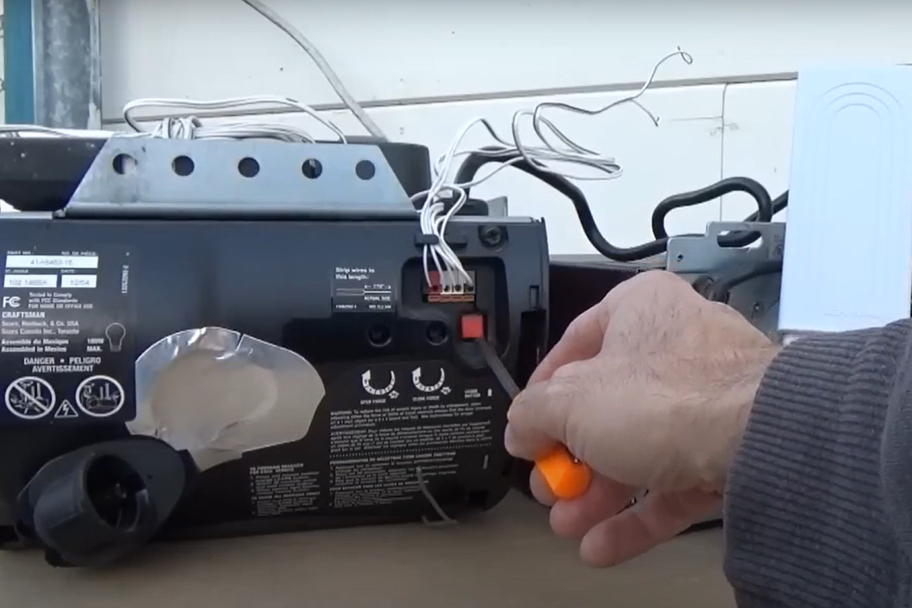 a skilled technician performing a garage door opener repair on a residential garage in Gahanna, Ohio, showcasing the detailed process of fixing and maintaining garage door systems for optimal functionality and safety.
