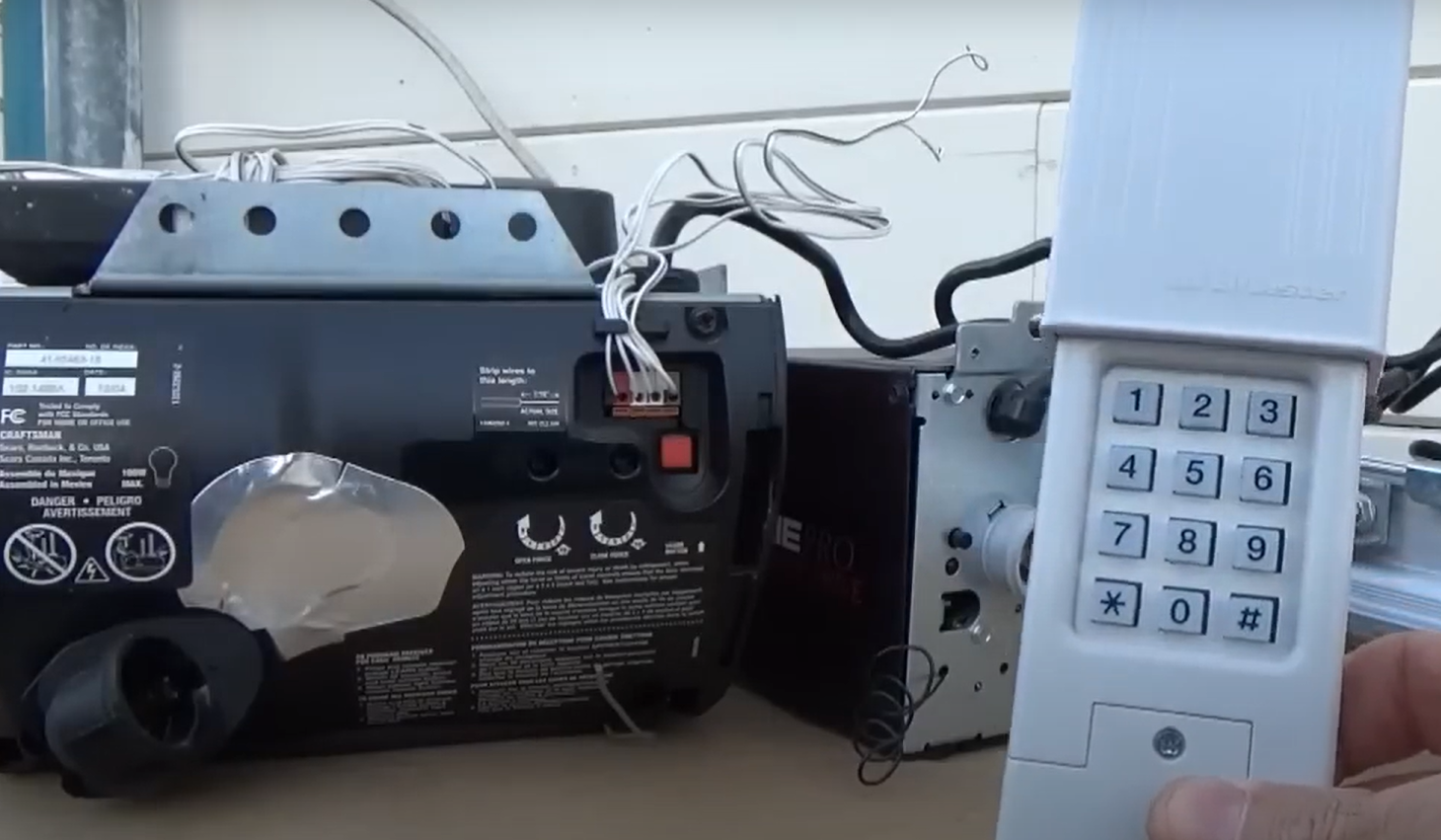 Technician repairing a garage door opener in Gahanna, Ohio, showcasing professional garage door repair services.